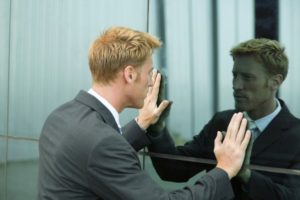 Man looking at reflection in window